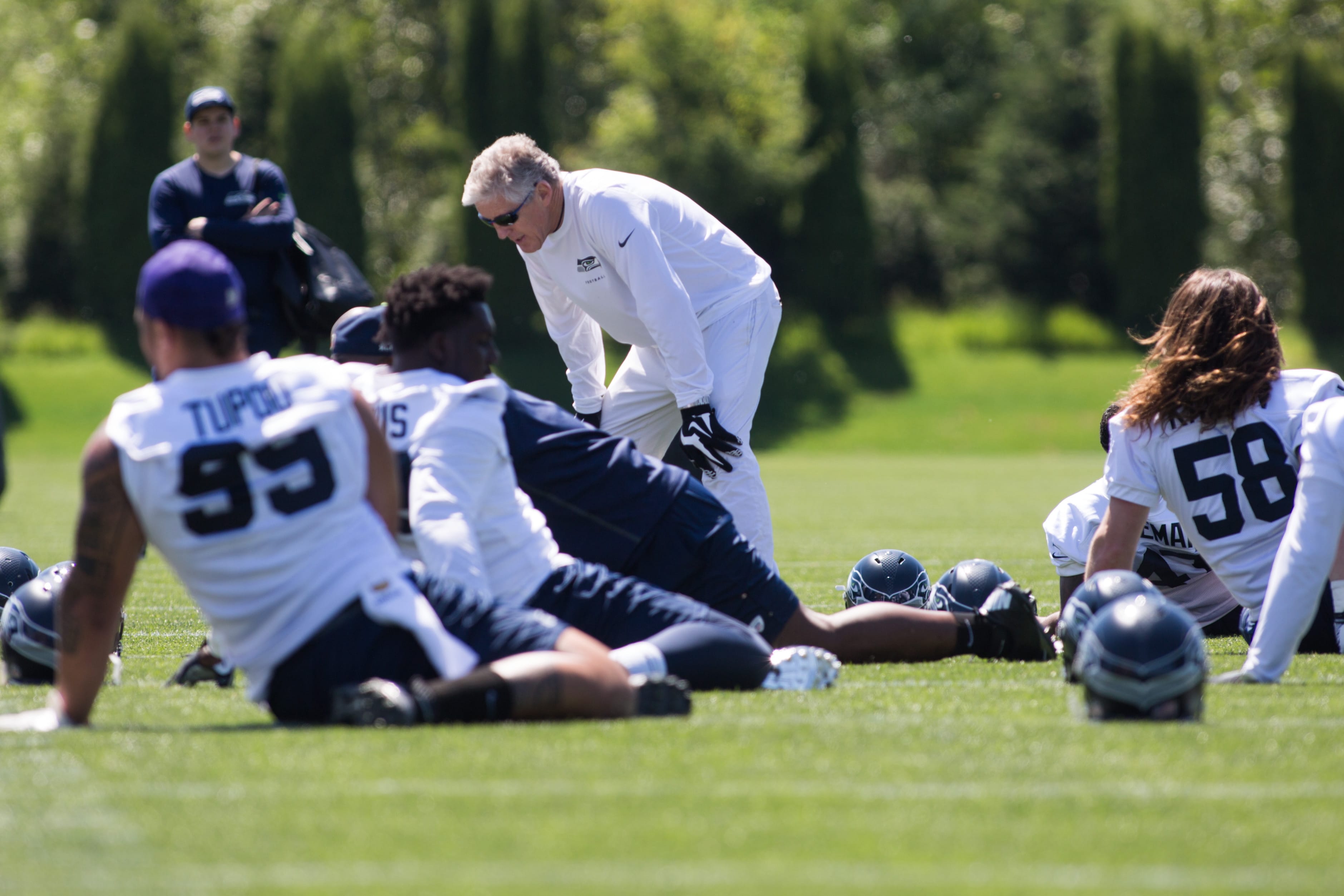 Head coach Pete Carroll talks to players as they stretch during the first day of the Seattle Seahawks NFL football rookie minicamp on Friday, May 6, 2016 at Virginia Mason Athletic Center in Renton, Wash.
