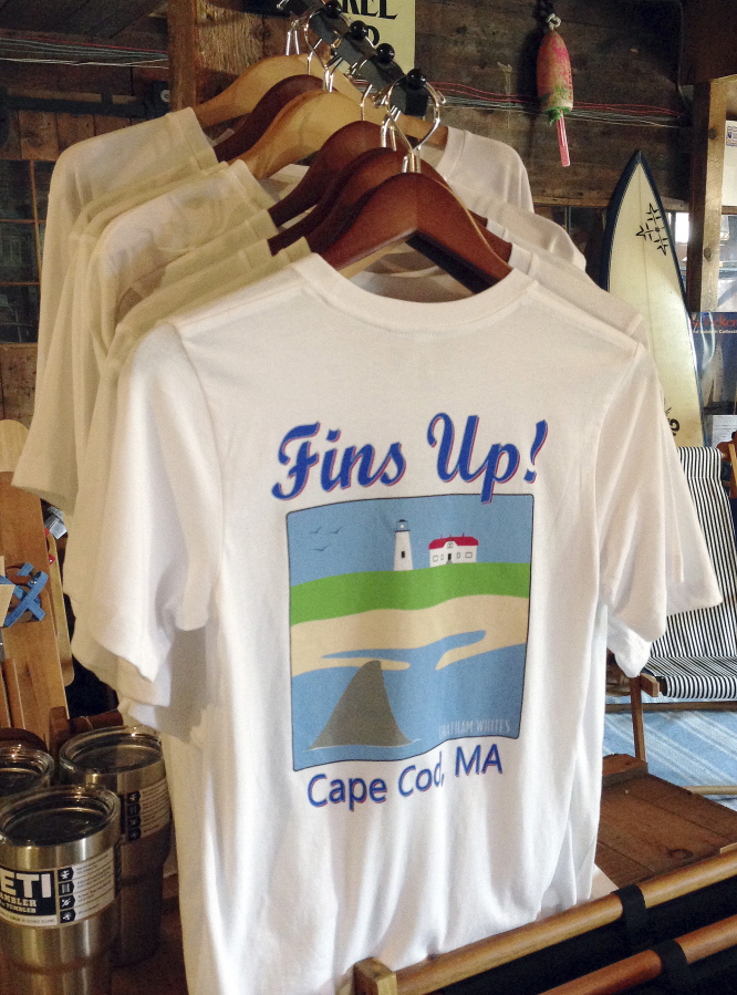 A shark-themed T-shirt is on sale in a souvenir shop in Harwich, Mass.