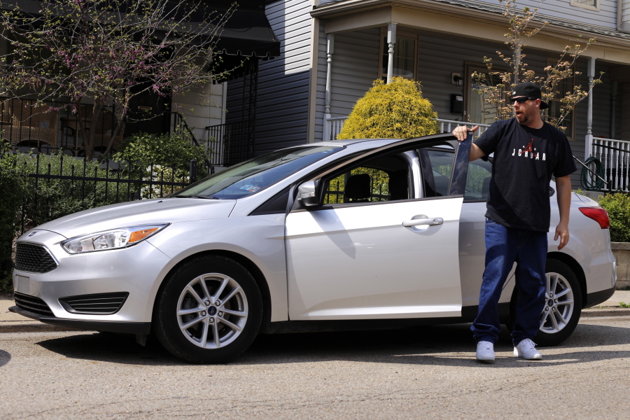 Louis Cervi gets out of his leased Ford Focus after parking near his Pittsburgh home. Cervi had been looking to buy a small car for basic transportation, with a reasonable monthly payment. (Gene J.
