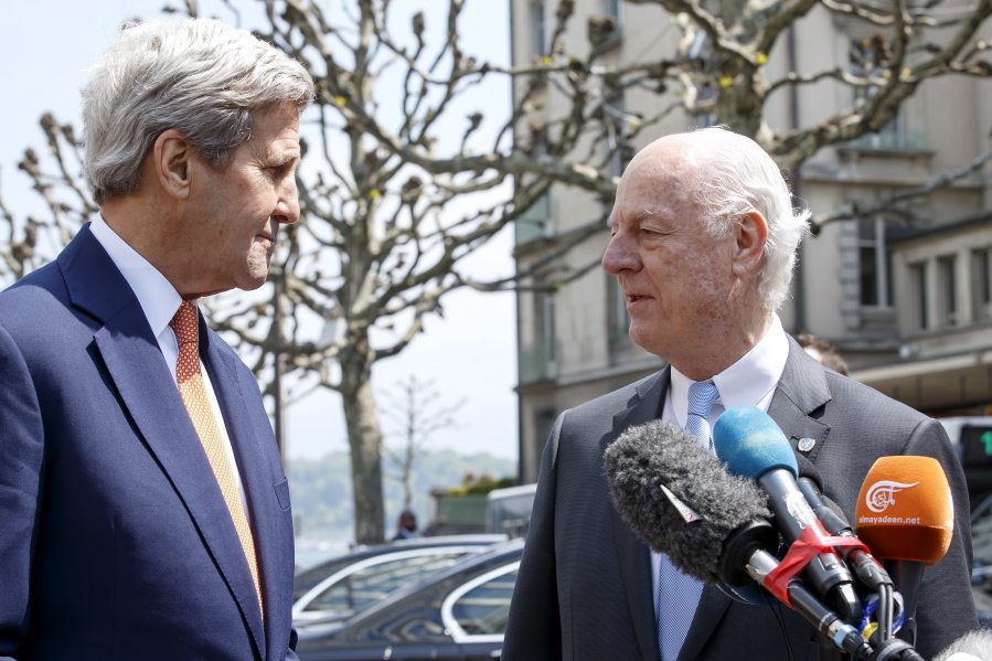 U.S. Secretary of State John Kerry, left, and the UN Special Envoy for Syria Staffan de Mistura, right, talk to each others during a press briefing after their meeting on Syria in Geneva, Switzerland, on Monday.
