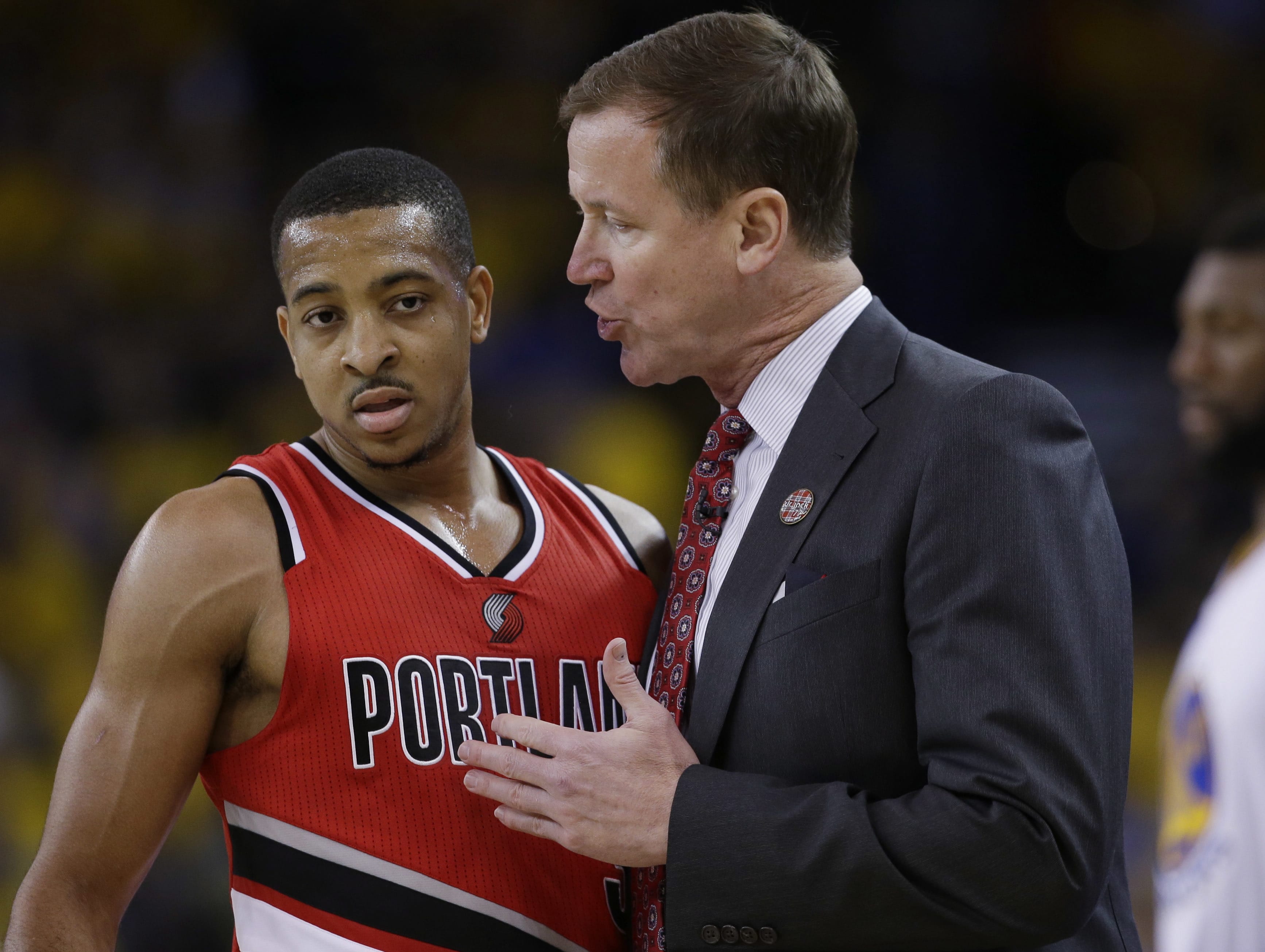 Portland Trail Blazers coach Terry Stotts, right, talks to guard C.J. McCollum during the first half in Game 5 of the team's second-round NBA basketball playoff series against the Golden State Warriors on Wednesday, May 11, 2016, in Oakland, Calif.