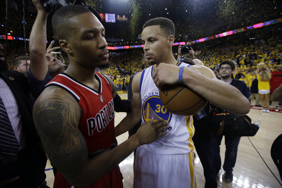 Golden State Warriors&#039; Stephen Curry, right, talks with Portland Trail Blazers&#039; Damian Lillard (0) at the end of Game 5 of a second-round NBA basketball playoff series Wednesday, May 11, 2016, in Oakland, Calif. Golden State won 125-121.