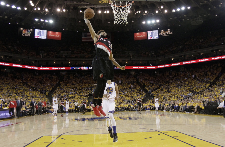 Portland Trail Blazers guard Allen Crabbe dunks in front of Golden State Warriors guard Shaun Livingston during the second half in Game 2 of a second-round NBA basketball playoff series in Oakland, Calif., Tuesday, May 3, 2016. The Warriors won 110-99.