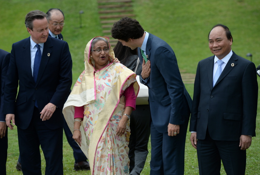 Canada Prime Minister Justin Trudeau talks with Prime Minister of Bangladesh Sheikh Hasina on Friday as they take part in a family photo at the G-7 Summit in Shima, Japan.