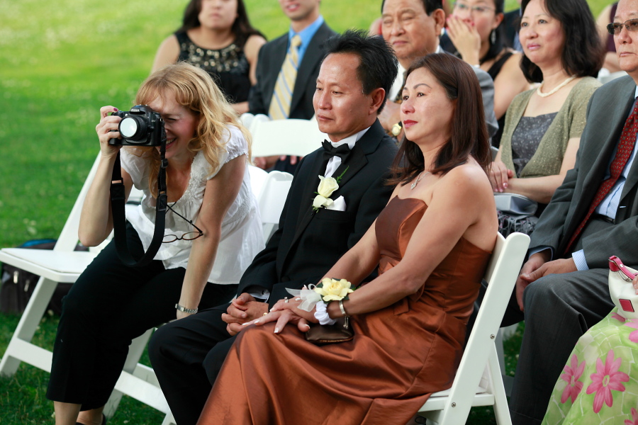 Wedding photographer Andi Schreiber, left, documents the wedding ceremony of Jennifer Chen and Tony Tran in 2010 at Wainwright House in Rye, New York.