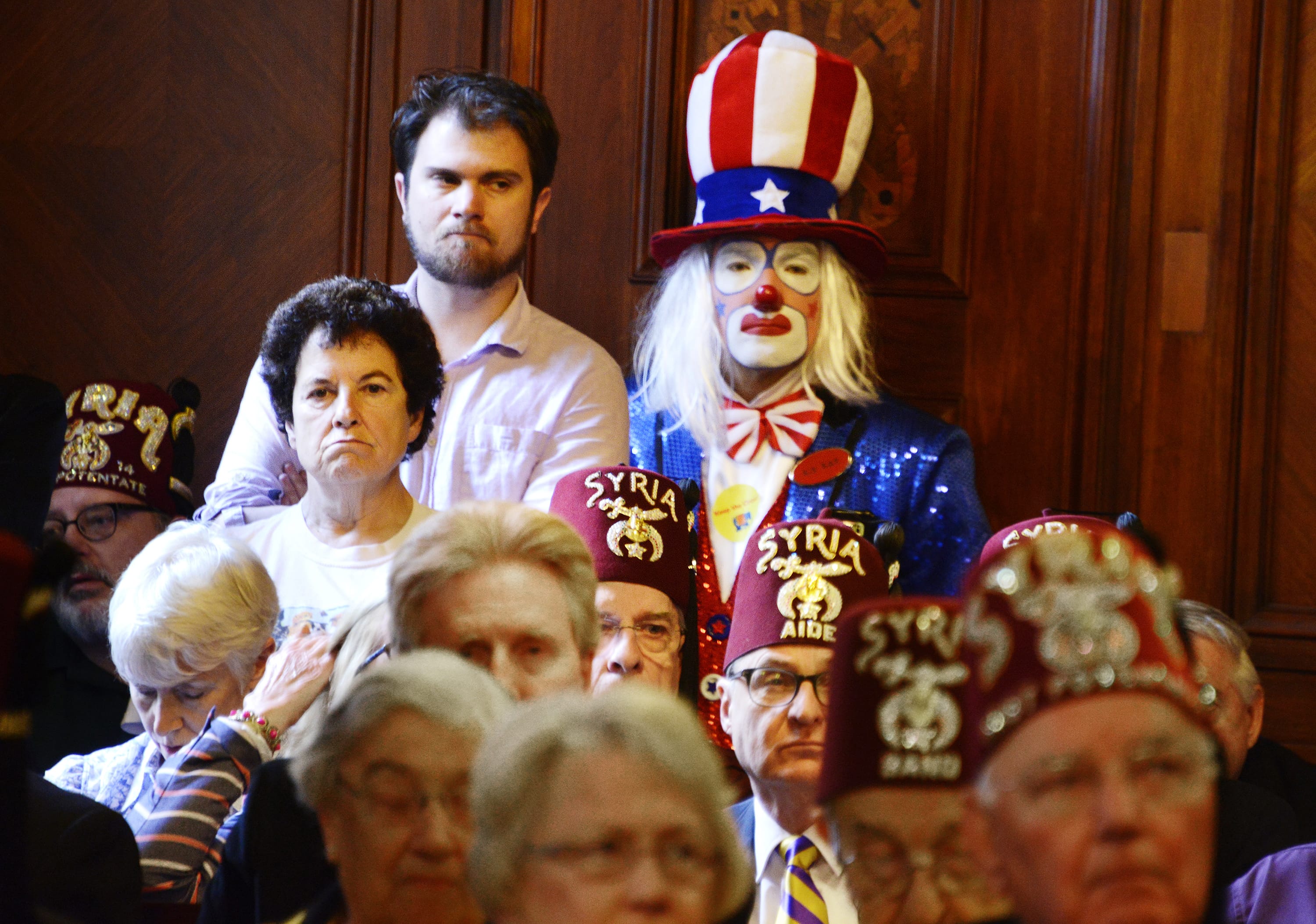 Clowns, including Jeff Cox, back, crowd the City Council chamber during a City Council hearing on a proposed wild-animal entertainment ban that would keep circuses and similar shows out of the city, Tuesday, May 24, 2016. Syria Shrine clowns also held signs outside the City-County Building begging the City Council not to enact the measure.