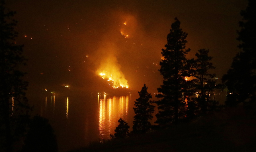 Timber burns in the First Creek fire near lakeside structures on the western shore of Lake Chelan near Chelan in 2015.  (AP Photo/Ted S.