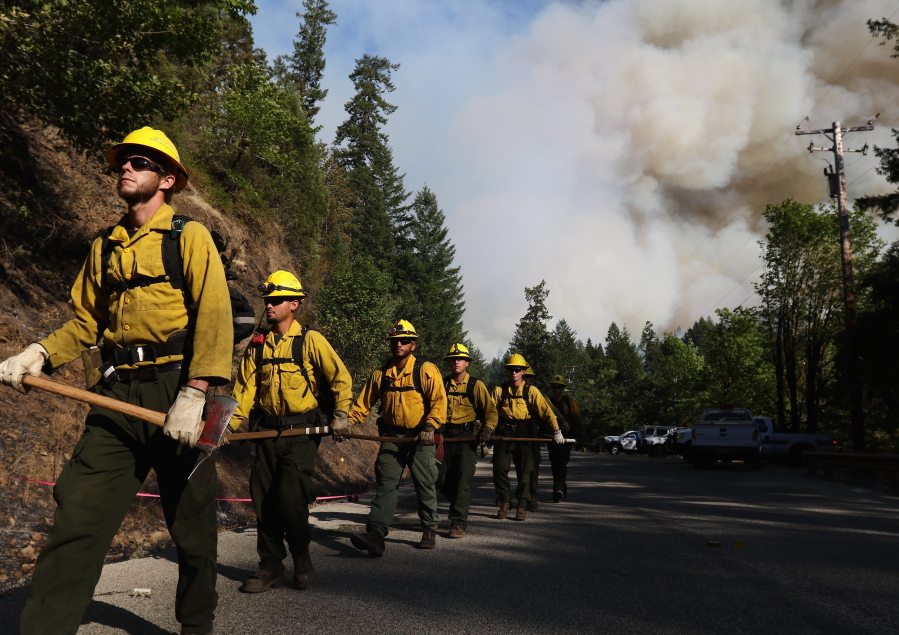 Department of Forestry firefighters prepare for work in 2015 at the Cable Crossing Fire near Glide, Ore. The National Interagency Coordinating Center is releasing its report on the outlook for the 2016 summer wildfire season nationwide.