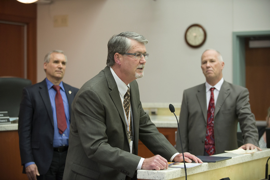 County Manager Mark McCauley, center, speaks to the crowd after proclaiming National County Government Month as Clark County Councilors David Madore, left, and Marc Boldt look on at an April Clark County council meeting at the Public Service Center. The council is granted McCauley a new, 18-month contract at Tuesday&#039;s meeting.