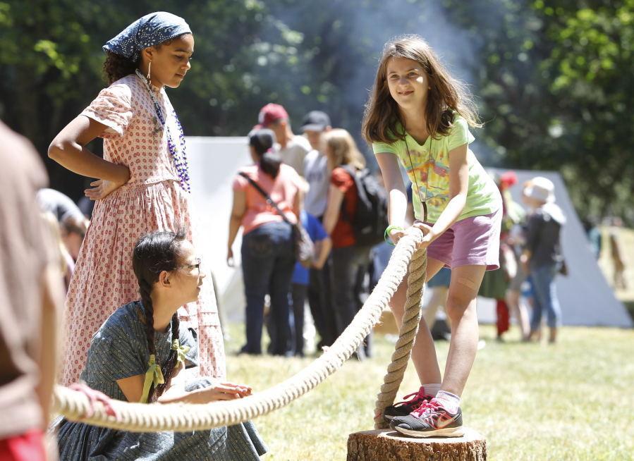 Ila Welburn, right, tries a game of  tug of war at the 2015 National Get Outdoors Day and Brigade Encampment at Fort Vancouver National Historic Site.