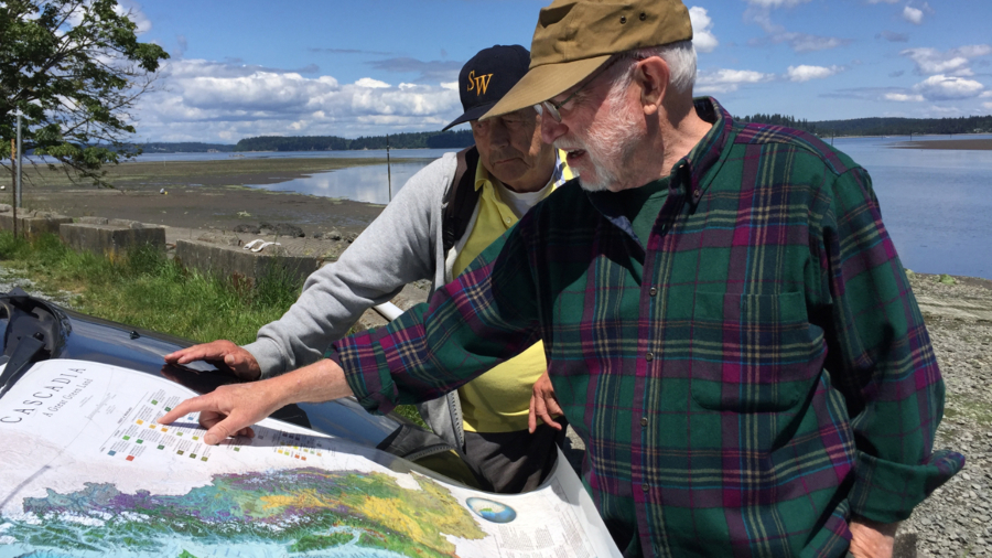 David McCloskey, right, with his map of Cascadia at Nisqually Reach on the southern shore of Puget Sound.