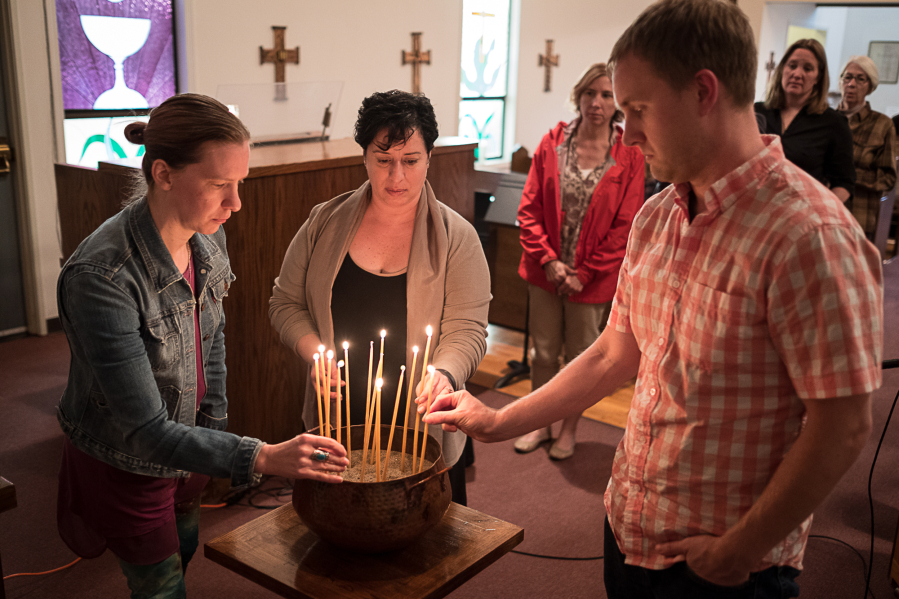 Attendees of a vigil Wednesday at St. Anne's Episcopal Church in Washougal light candles to honor the victims of the Orlando shooting. At center is Rabbi Elizabeth Dunsker of Congregation Kol Ami.