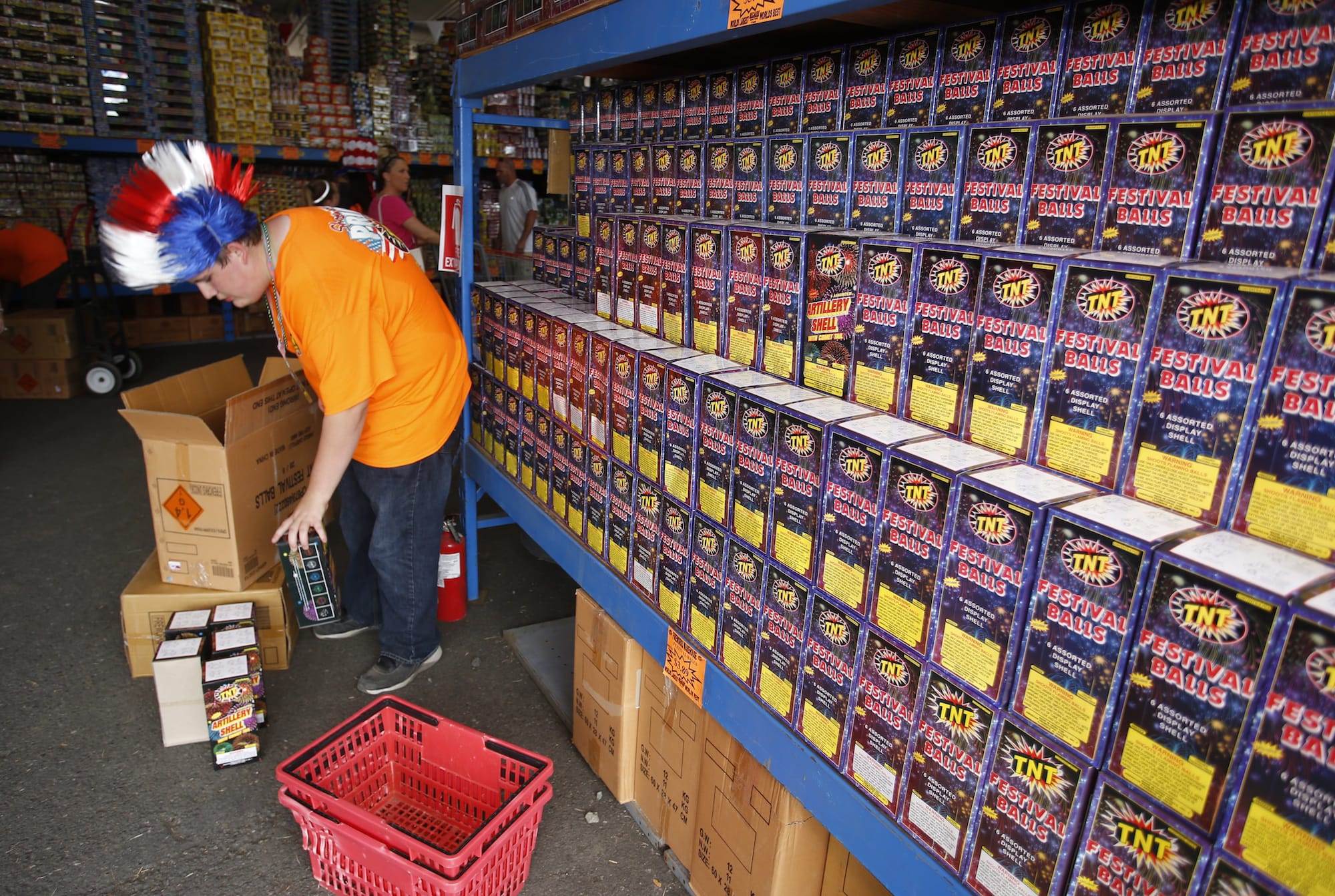 A worker stocks the TNT Fireworks warehouse prior to last year’s sales.