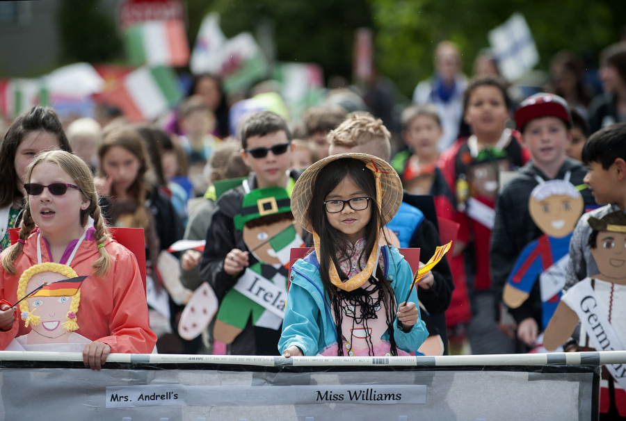 Lake Shore Elementary School third-grader Madison Nguyen, 9, center, honors the country of Vietnam while leading classmates along the parade route  May 27 at Fort Vancouver National Historic Site.