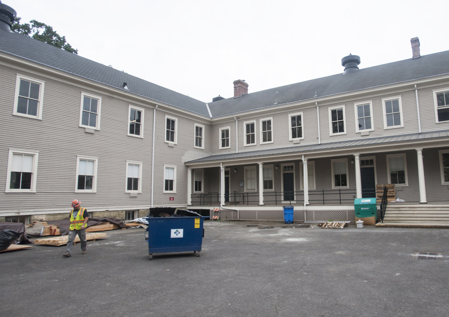 A construction worker walks behind  the Artillery Barracks as renovation takes place Thursday at the West Vancouver Barracks campus owned by the city of Vancouver.