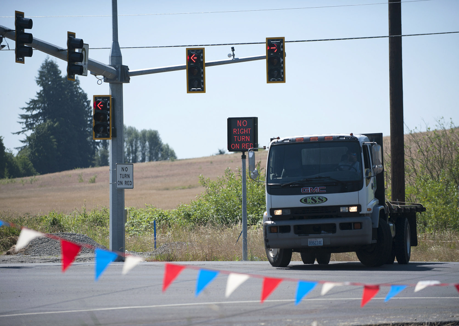 A driver makes a U-turn on Monday while using the new U-turn only lane for large trucks on state Highway 502. It&#039;s just one part of the $84.4 million project to upgrade the road that officially wrapped up on Monday.