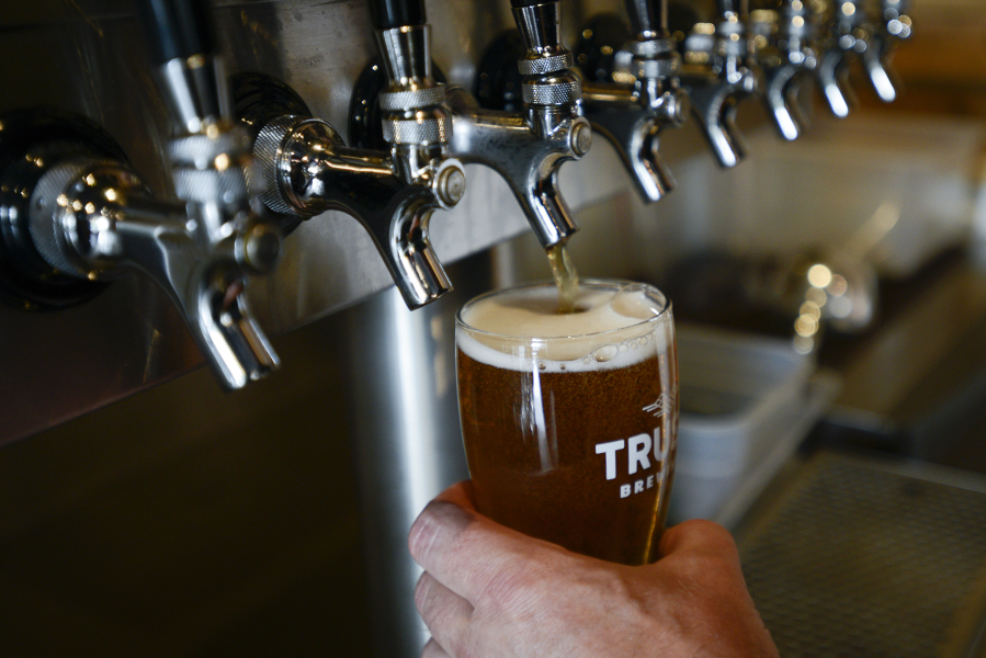 Gary Paul, the owner of Trusty Brewing Co., pours his lauded Corner Window IPA at his Vancouver brewery on Thursday afternoon.