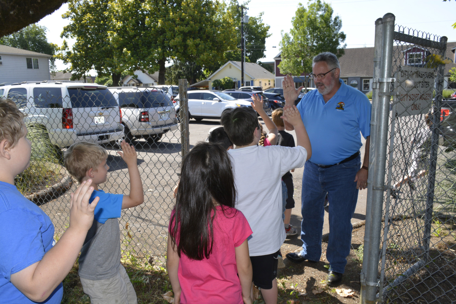 Gause Elementary School students visit, and high five, Washougal Mayor Sean Guard on a field trip where they learned about different services the city provides while visiting City Hall, the library and police and fire stations.