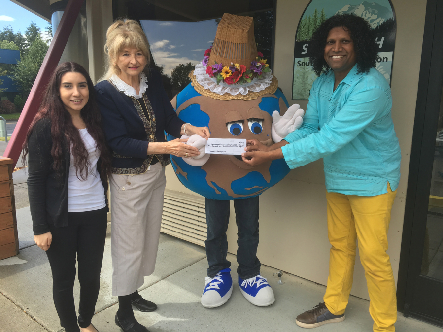 From left: Deanna Camarena, environmental educator, Jane Bosteder, president of Environmental Awareness Programs, Mother Earth mascot and Karl Reddy, executive director of the Southwest Washington Center of the Deaf and Hard of Hearing celebrate a grant to help the nonprofit teach environmental education workshops.
