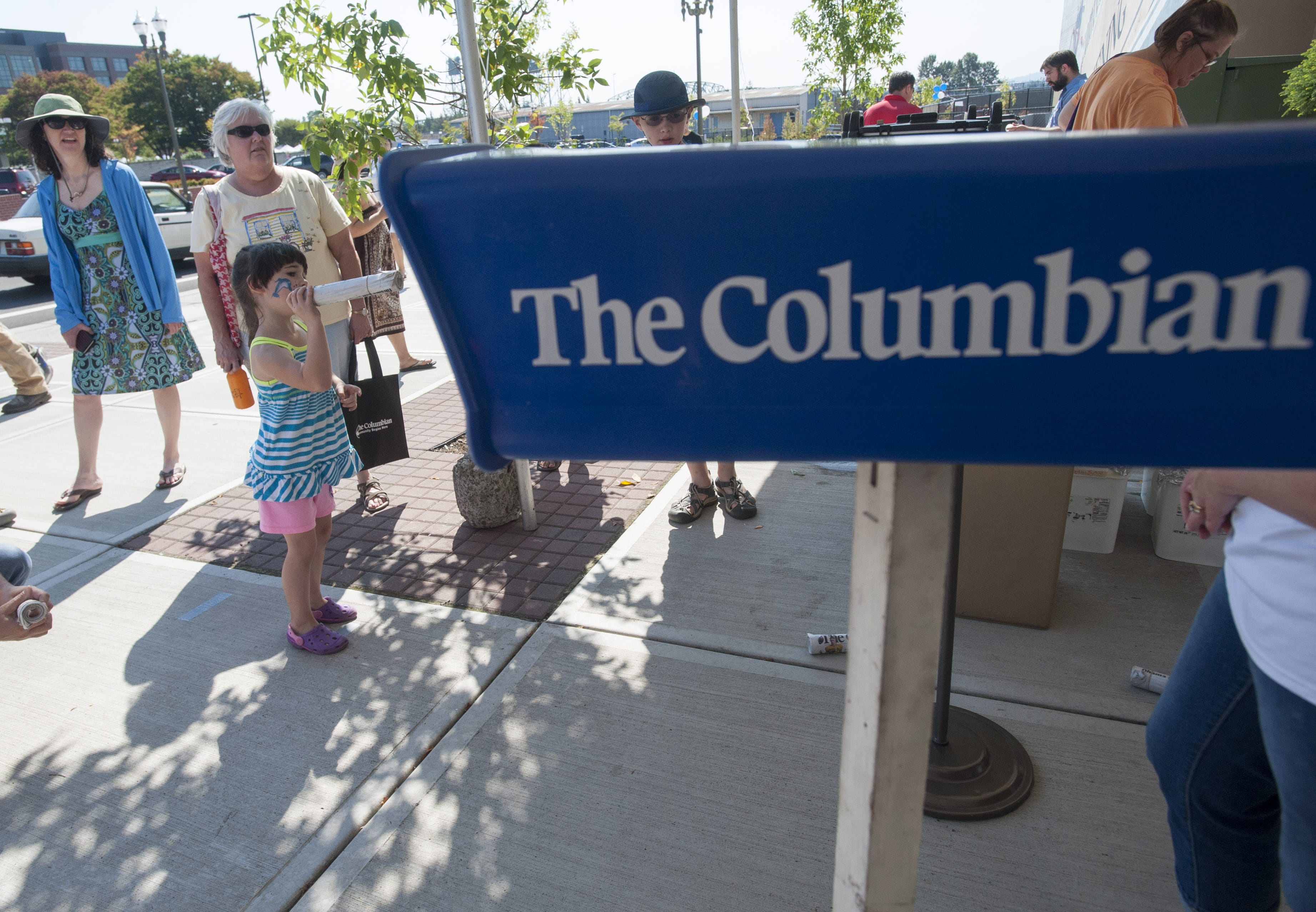 Bailey Rose played a game of throwing a paper in to a plastic receptacle at an event at The Columbian in Vancouver on Sept. 12. The event was held in advance of The Columbian newspaper's 125th anniversary in October. The Columbian announced layoffs on Wednesday.
