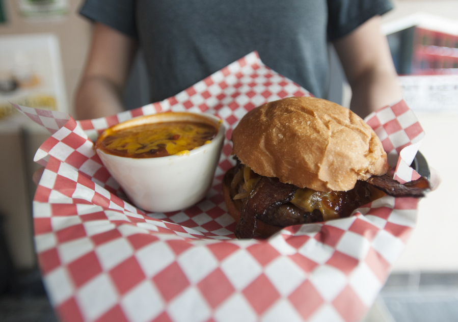 A bowl of house-made chili and a MooOink burger are served June 17 at the Old Ivy Brewery &amp; Taproom in downtown Vancouver.