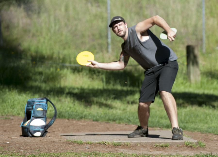 Casey Kramer plays disc golf at Leverich Park in Vancouver. A plan to build another course in Vancouver, at Frenchman&#039;s Bar Park, has been put on hold.
