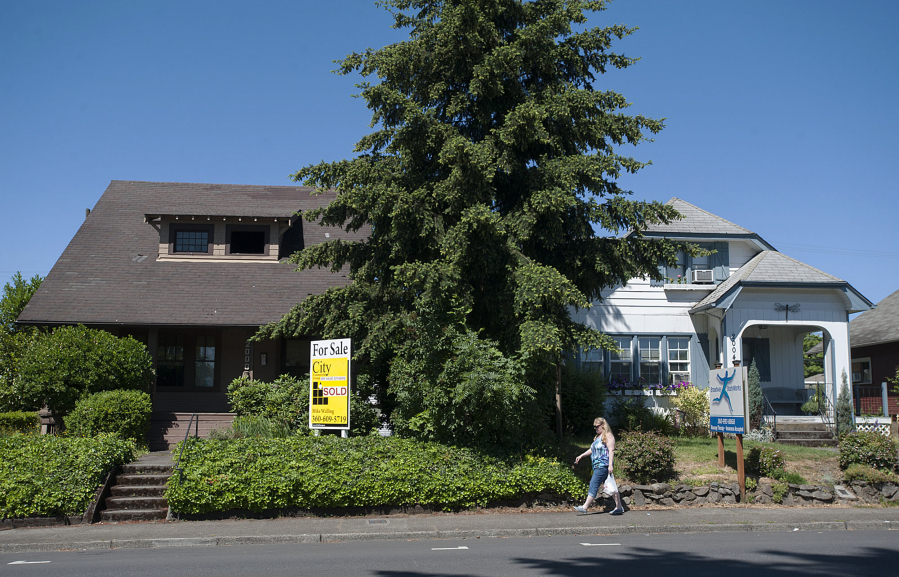 The houses at 2000 Broadway, left, and 2004 Broadway could make way for a three-story building with 23 apartments and seven live-work units if Vancouver approves an application now under review.
