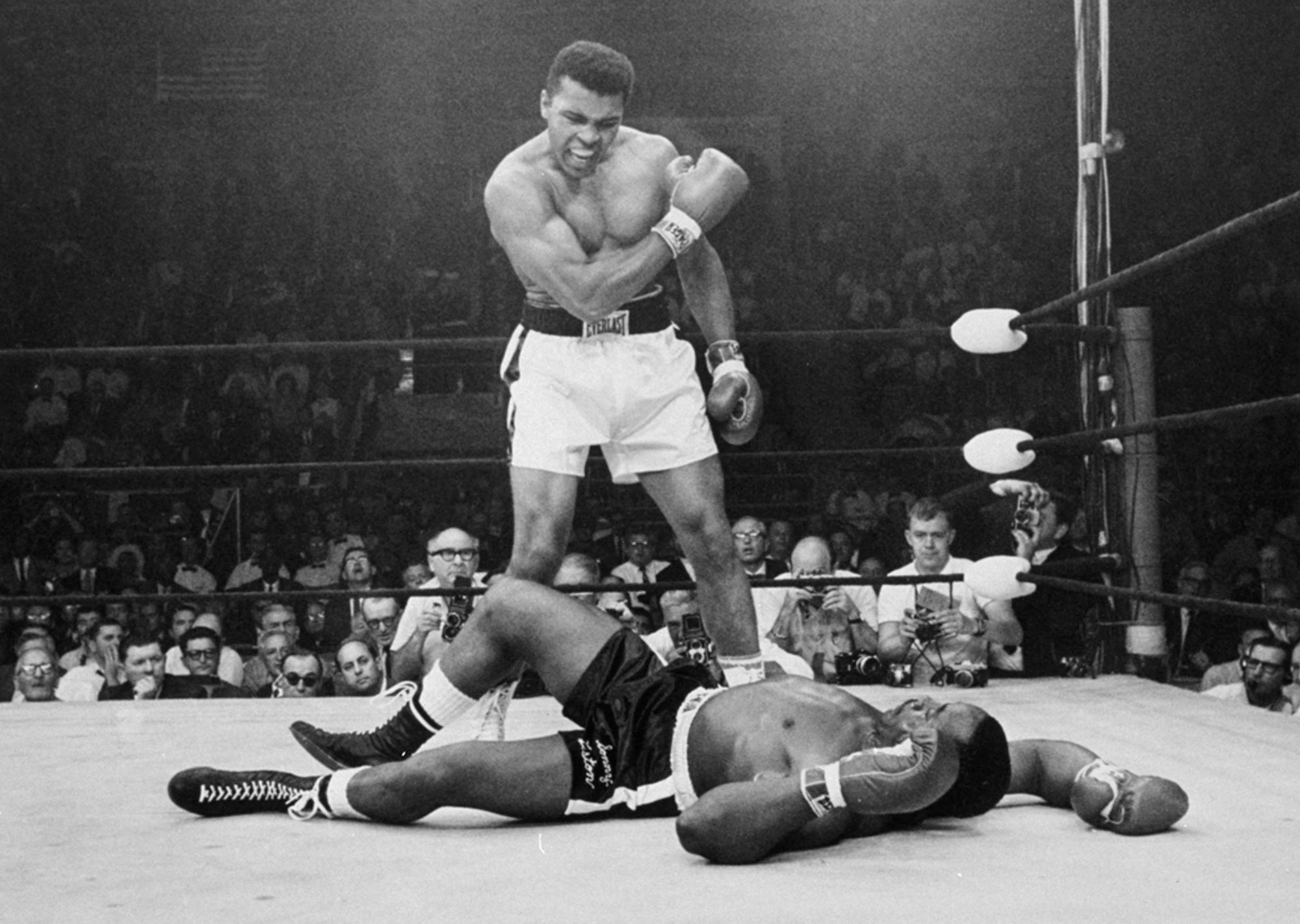 In this May 25, 1965, photo, heavyweight champion Muhammad Ali, then known as Cassius Clay, stands over challenger Sonny Liston, shouting and gesturing shortly after dropping Liston with a short hard right to the jaw, in Lewiston, Maine. Ali, the magnificent heavyweight champion whose fast fists and irrepressible personality transcended sports and captivated the world, has died according to a statement released by his family Friday, June 3, 2016. He was 74.