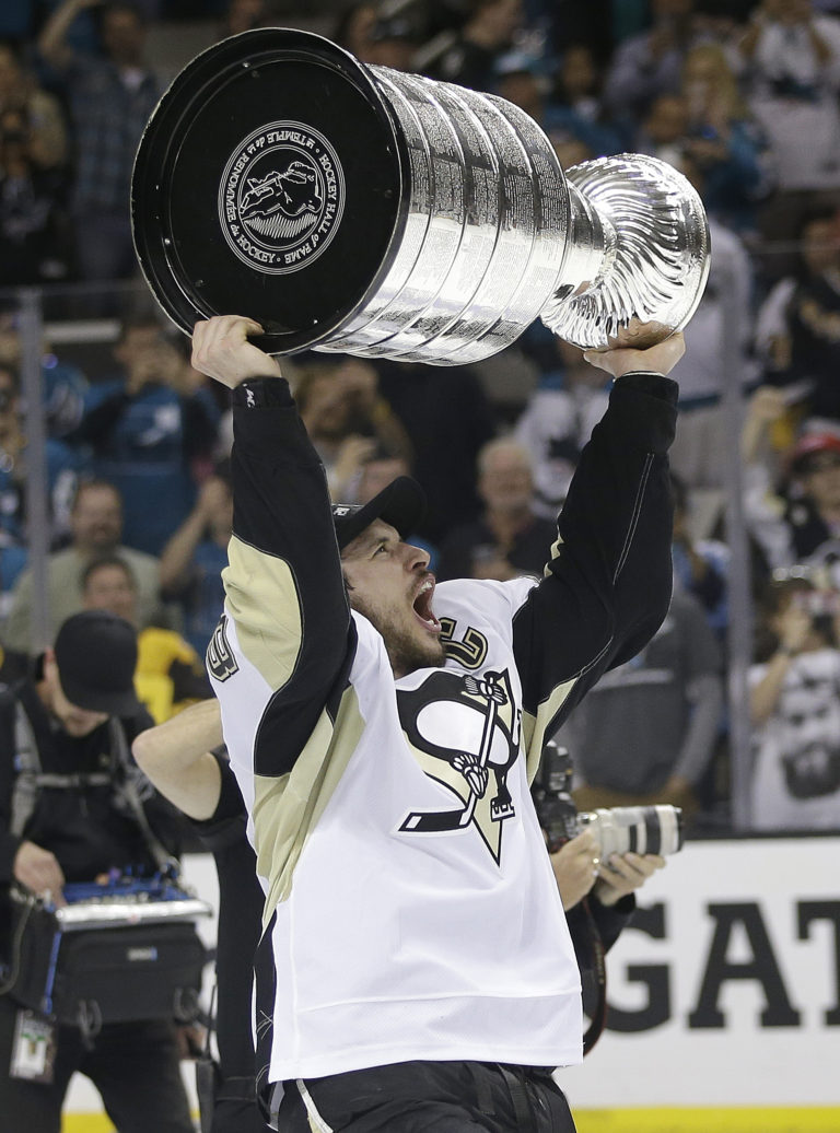 Pittsburgh Penguins center Sidney Crosby celebrates with the Stanley Cup after Game 6 of the NHL hockey Stanley Cup Finals against the San Jose Sharks in San Jose, Calif., Sunday, June 12, 2016. The Penguins won 3-1 to win the series 4-2.