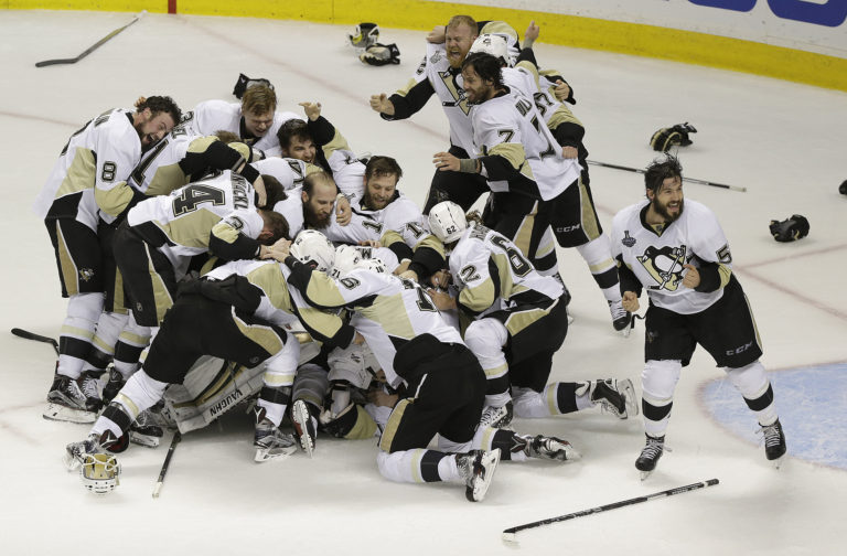 Pittsburgh Penguins players celebrate after beating the San Jose Sharks in Game 6 of the NHL hockey Stanley Cup Finals in San Jose, Calif., Sunday, June 12, 2016. The Penguins won 3-1 to win the series 4-2.