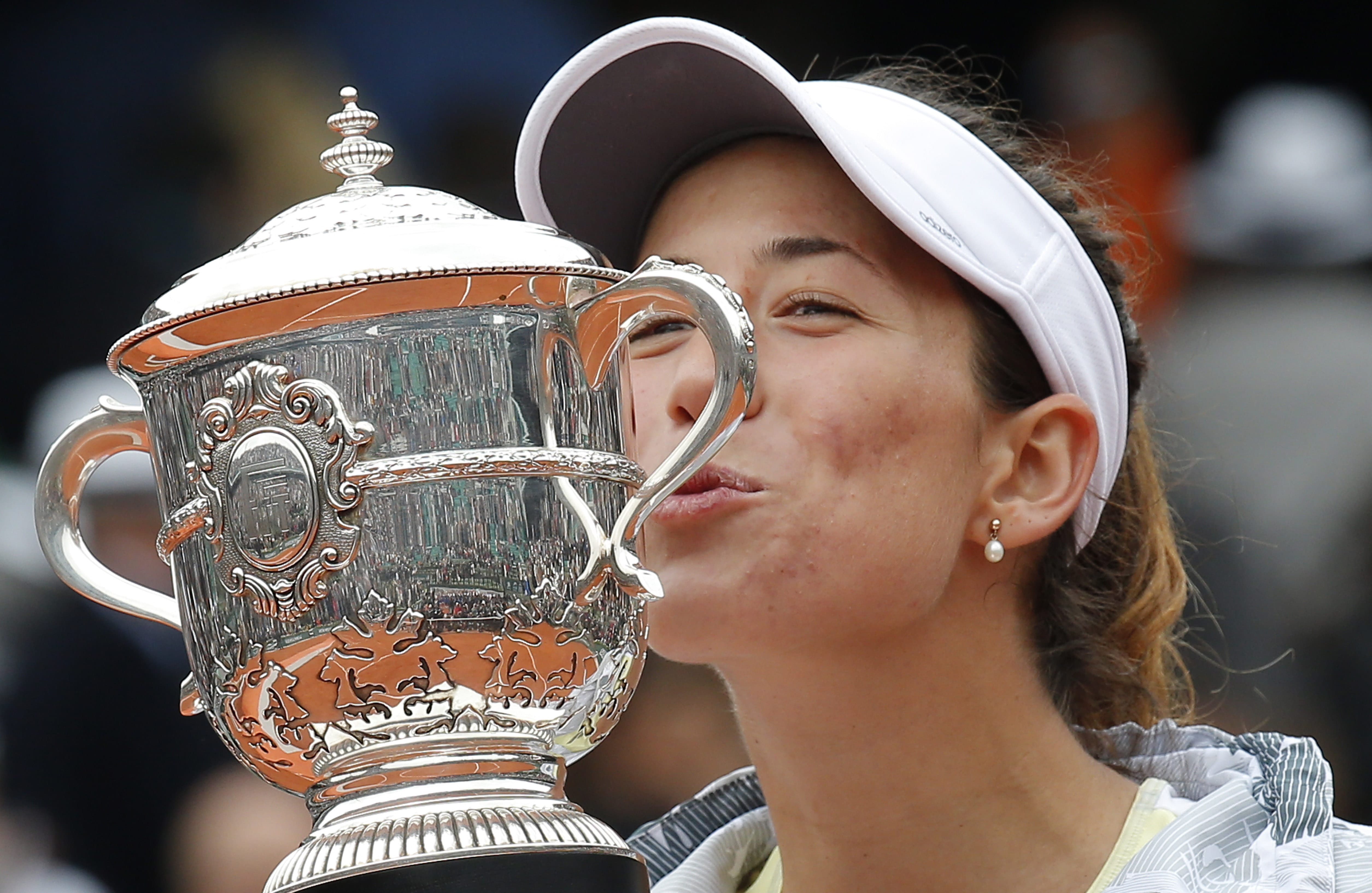 Spain's Garbine Muguruza is to kiss the cup after defeating Serena Williams of the U.S.  in their final match of the French Open tennis tournament at the Roland Garros stadium, Saturday, June 4, 2016 in Paris.  Muguruza won 7-5, 6-4.