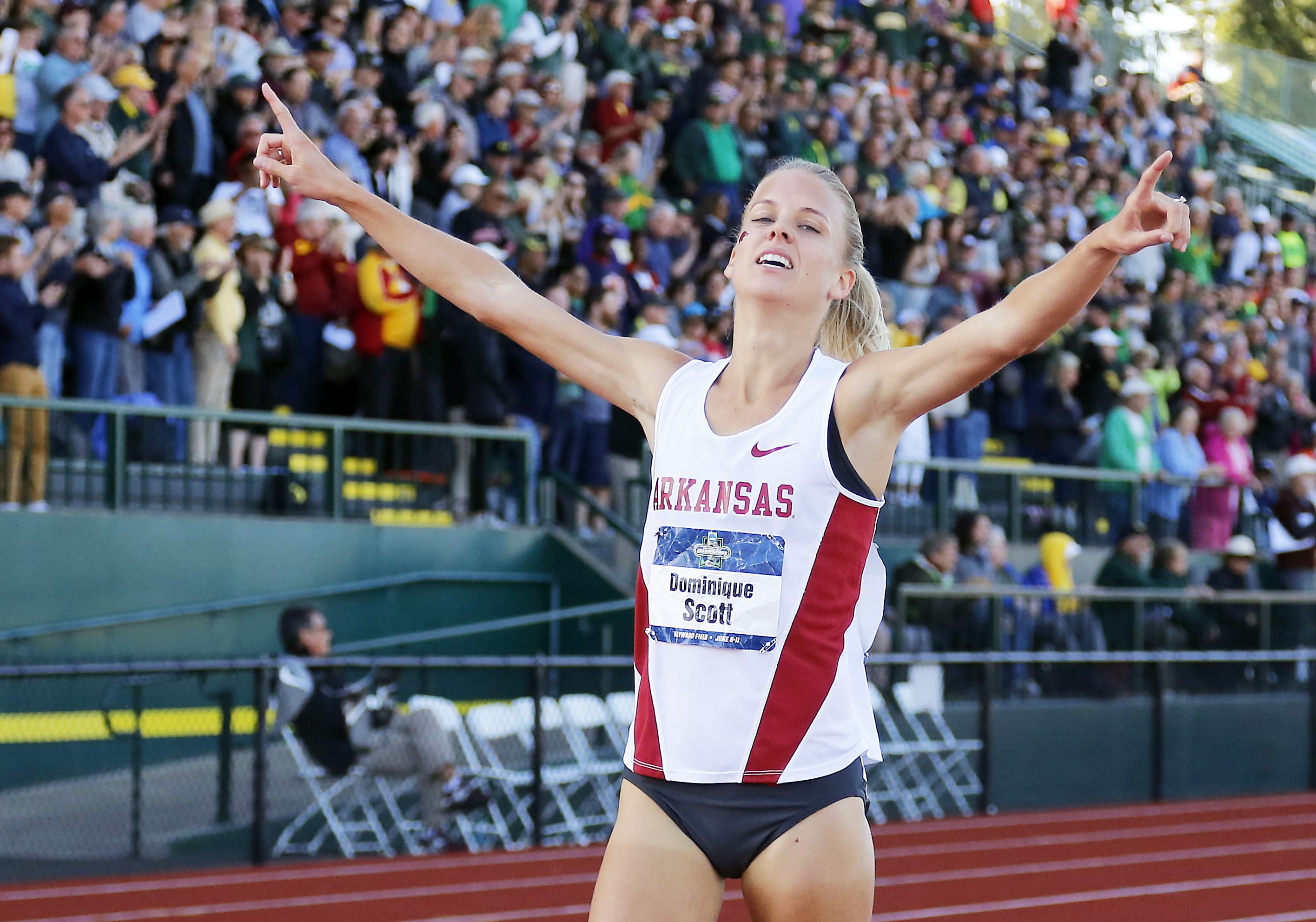 Arkansas' Dominique Scott points as she wins the women's 5,000 meters at the NCAA outdoor track and field championships in Eugene, Ore., Saturday, June 11, 2016.