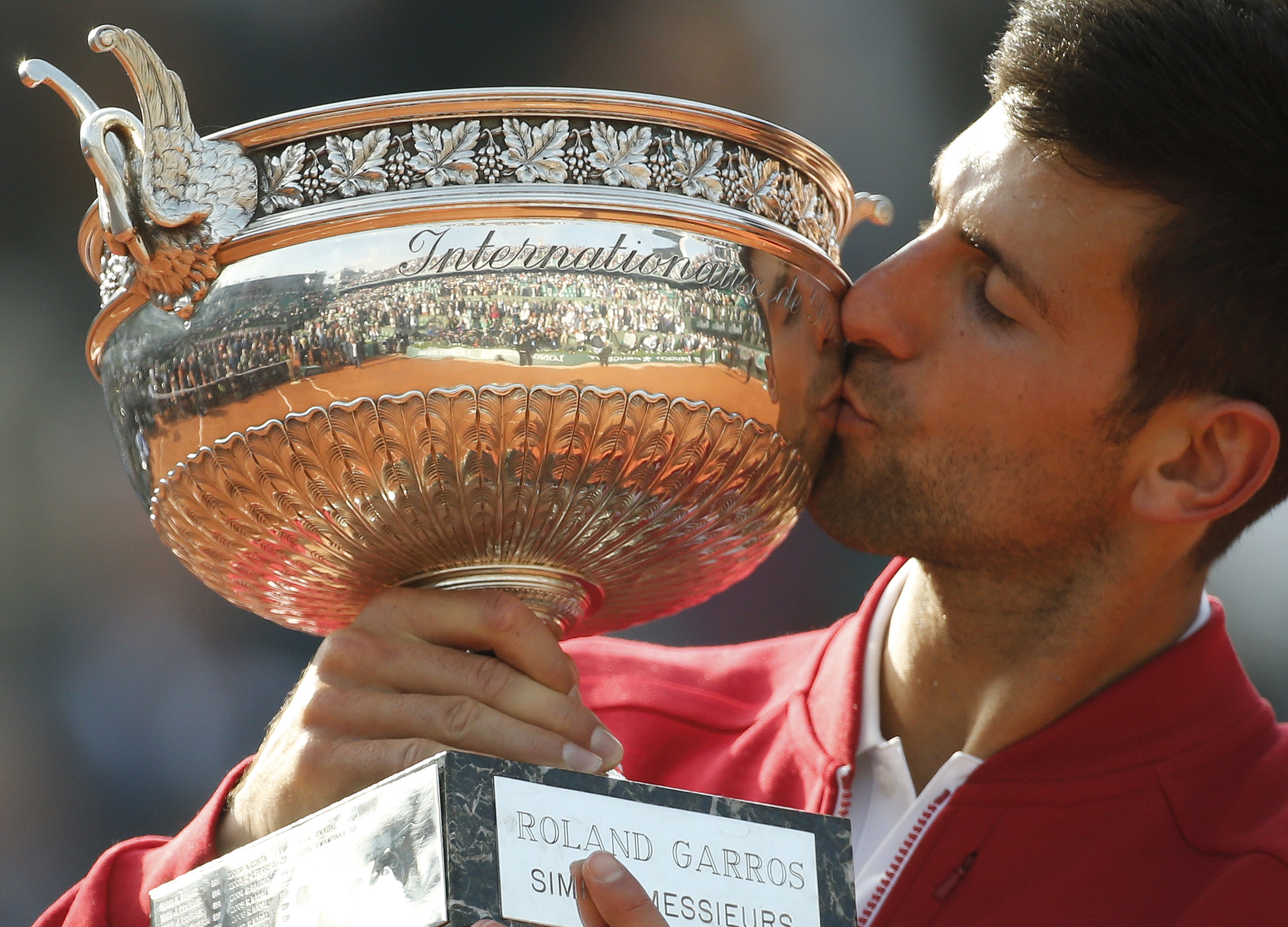 Serbia's Novak Djokovic kisses the cup after defeating Britain's Andy Murray in their final match of the French Open tennis tournament at the Roland Garros stadium, Sunday, June 5, 2016 in Paris.