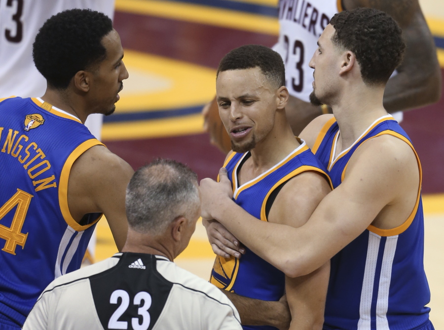 Golden State Warriors guard Stephen Curry is held back from referee Jason Phillips (23) by Shaun Livingston, left, and Klay Thompson, right, while reacting to being called for his sixth foul on Cleveland Cavaliers forward LeBron James (23) during the second half of Game 6 of basketball&#039;s NBA Finals in Cleveland, Thursday, June 16, 2016.
