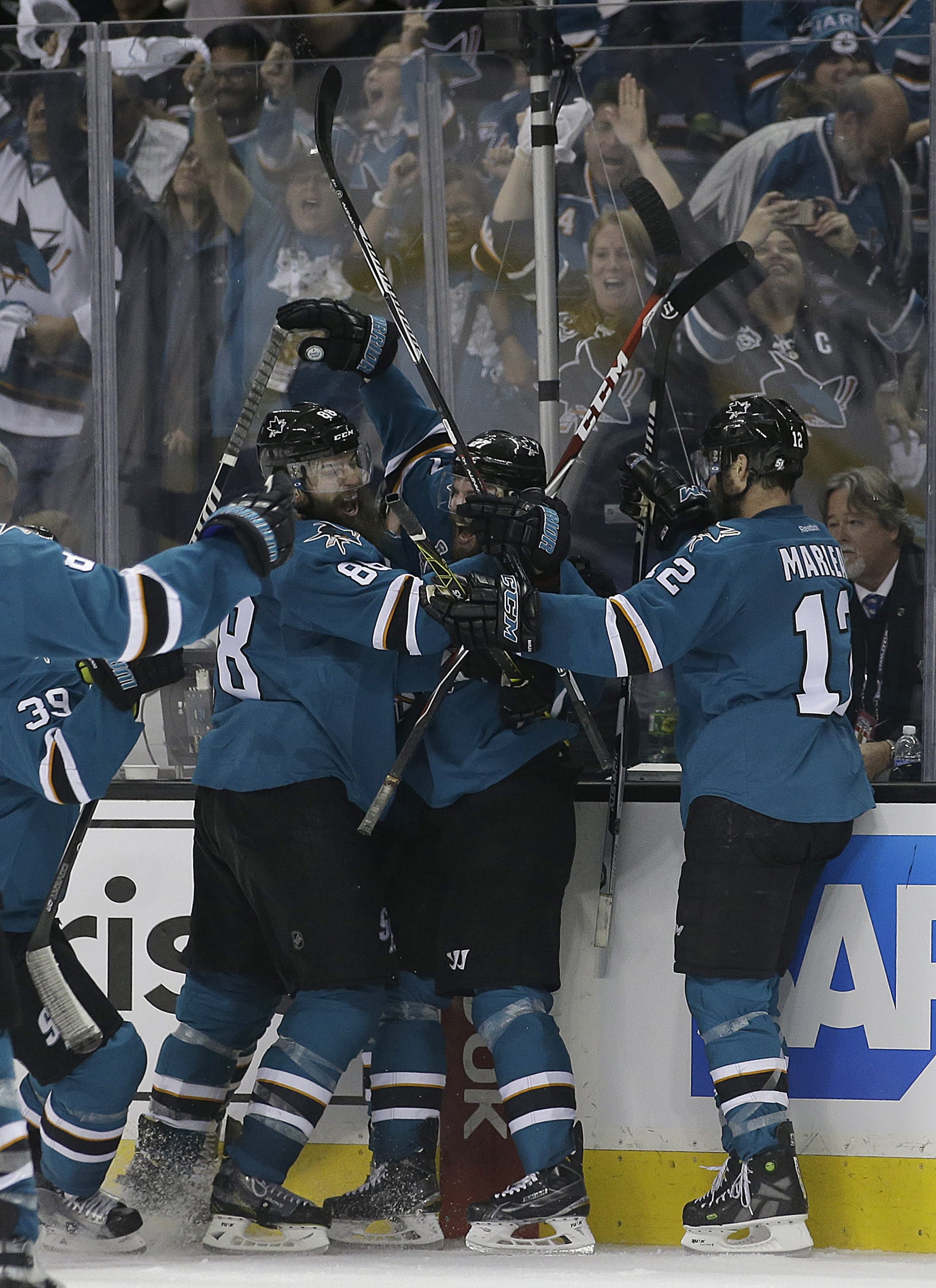 San Jose Sharks right winger Joonas Donskoi, center, celebrates with teammates after scoring the winning goal during overtime of Game 3 of the Stanley Cup Final against the Pittsburgh Penguins in San Jose, Calif., Saturday, June 4, 2016. The Sharks won 3-2.