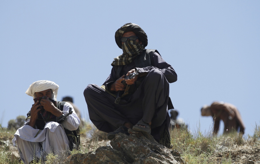 Taliban fighters guard May 27 as senior leader of a breakaway faction of the Taliban Mullah Abdul Manan Niazi, not pictured, delivers a speech to his fighters, in Shindand district of Herat province, Afghanistan. In the rugged terrain of the Taliban heartland in southern Afghanistan, the fight against Kabul has become a war for control of key stretches of main roads and highways as the insurgents use a new tactic to gain ground.