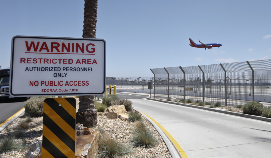 A commercial airliner lands May 13 at San Diego International Airport, where multiple layers of fencing topped with razor wire protects the airport grounds. An Associated Press investigation has documented perimeter breaches at many of the busiest airports in the U.S.