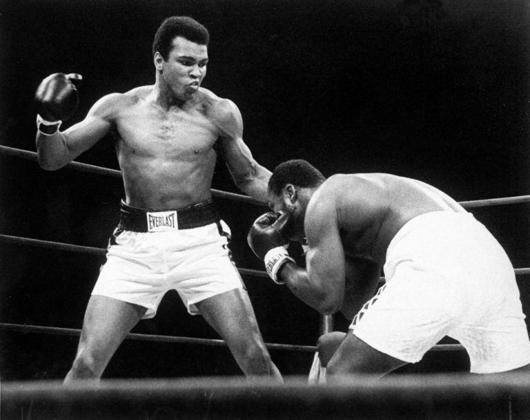 Muhammad Ali throws  a punch at Joe Frazier, right, during their bout at Madison Square Garden in New York, in this Jan. 28, 1974, photo.