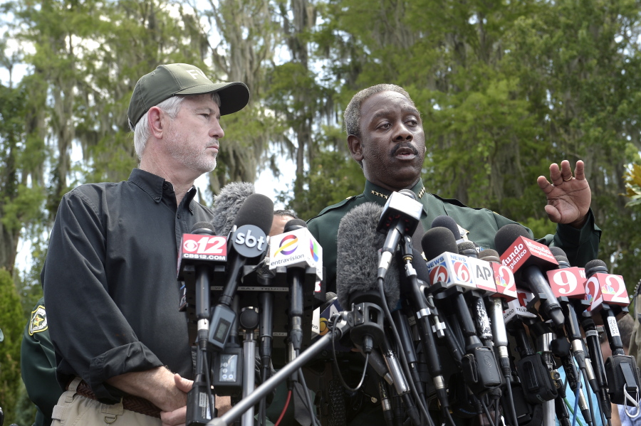 Nick Wiley, executive director of the Florida Fish &amp; Wildlife Conservation Commission, left, and Orange County Sheriff Jerry Demings answer questions from reporters during a news conference Wednesday in Lake Buena Vista, Fla., after a toddler was dragged into the lake Tuesday eveningby an alligator outside Disney&#039;s Grand Floridian Resort &amp; Spa. (AP Photo/Phelan M.