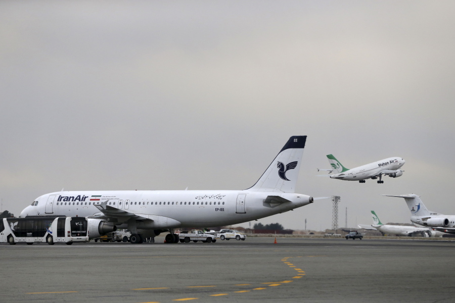 An Iranian Mahan Air passenger plane takes off as a plane of Iran&#039;s national air carrier, Iran Air, is parked at left, at Mehrabad airport in February in Tehran, Iran.
