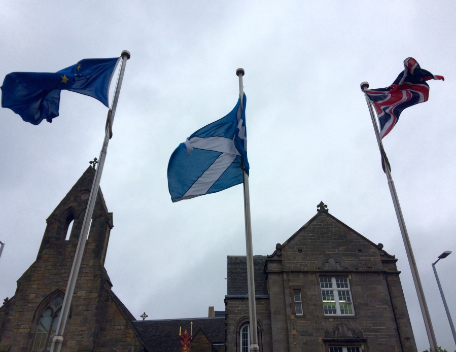 An EU flag, a Scottish flag and an Union Jack, left to right, wave outside Scottish parliament in front &quot;The Queen&#039;s Gallery&quot; in Edinburgh. Scottish voters who want Britain to remain part of the EU would be so unhappy if it decided to break away that they would back a second referendum on forming their own independent nation.