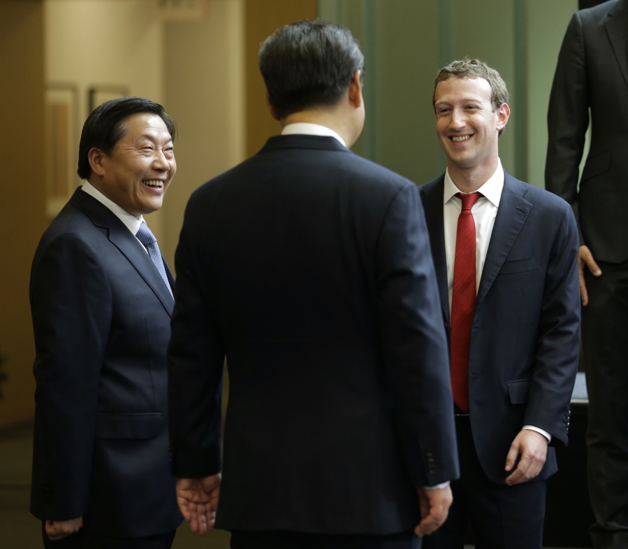 Chinese President Xi Jinping, center, talks with Facebook Chief Executive Mark Zuckerberg, right, as Lu Wei, left, China&#039;s Internet czar, looks on during a gathering of CEOs and other executives at Microsoft&#039;s main campus in Redmond, Wash. China is replacing its top internet regulator and censor, Lu Wei, who had become the face of the government&#039;s increasingly complicated dealings with foreign technology companies. (AP Photo/Ted S.