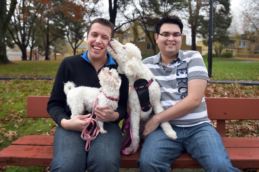 In this Nov. 28, 2015 photo, Jeremy Mark, left, and David Beltier, sit with their dogs, Beauty and Princess, near their home in Hillsboro, Ore. In March 2013, Beltier was walking with boyfriend Mark, and their poodle when a man in a truck began yelling homophobic slurs at the pair, got out of his truck and began punching Beltier. The man, leaving at one point to grab a metal tool from the truck and hit Beltier again in the head, was later charged with state and federal hate crimes. Yet what happened to Beltier was never included in the FBI&#039;s national hate crimes report because the Hillsboro Police Department was among those found to be not reporting to the FBI during the six-year period of 2009-2014 examined by The Associated Press.