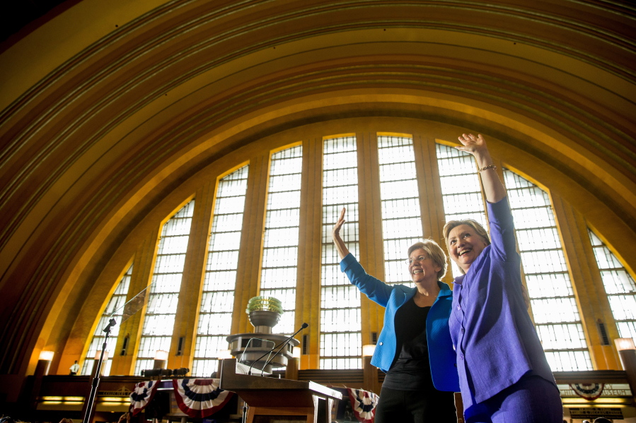 Democratic presidential candidate Hillary Clinton, accompanied by Sen. Elizabeth Warren, D-Mass., left, waves after speaking at the Cincinnati Museum Center at Union Terminal in Cincinnati on Monday.
