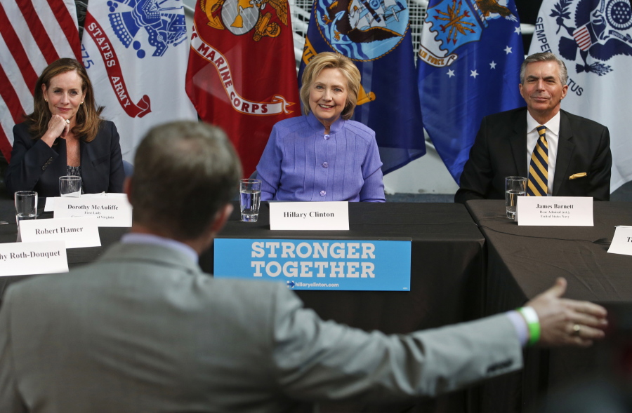 Democratic Presidential candidate Hillary Clinton, center, flanked by Virginia First Lady, Dorothy McAuliffe and retired Adm. James Barnett, listens to a question during a panel discussion on national security Wednesday at the Virginia Air and Space Museum in Hampton, Va.