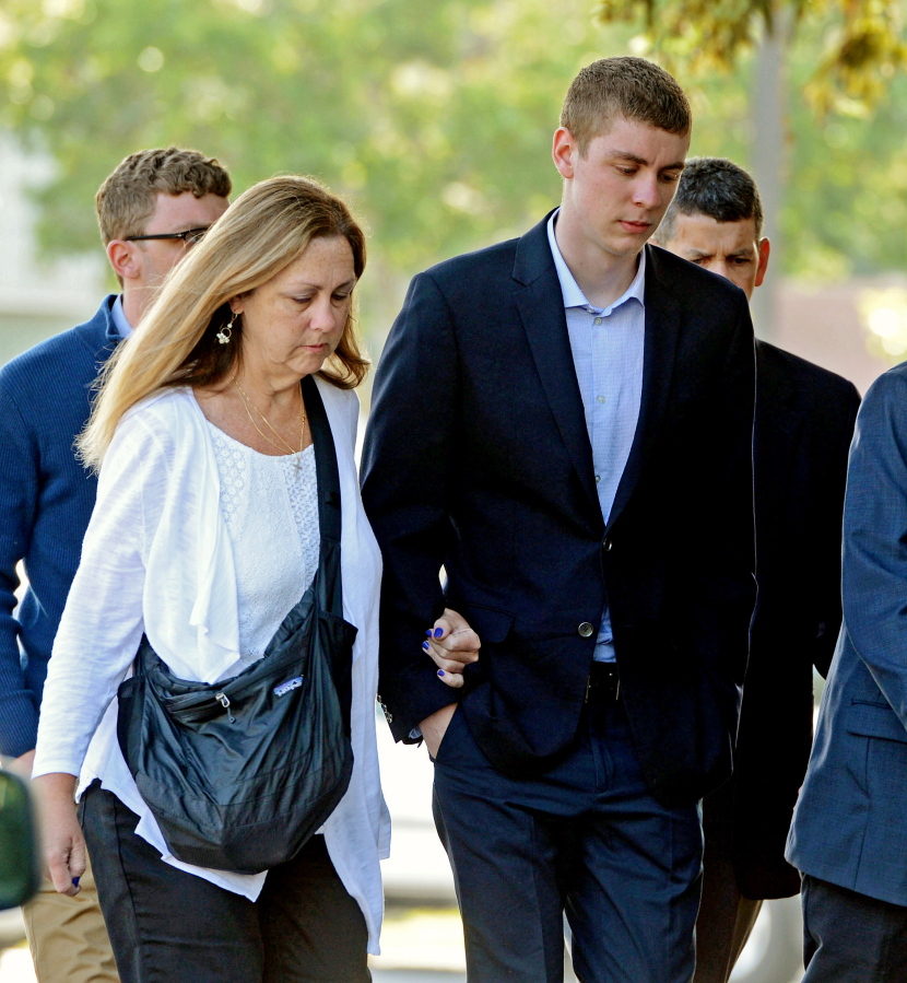 FILE - In this June 2, 2016 file photo, Brock Turner, right, makes his way into the Santa Clara Superior Courthouse in Palo Alto, Calif. Some parents are using the unusual publicity surrounding the sentencing of the student-athlete, Turner, at Stanford to talk to their own children about sexual misconduct, binge drinking, personal responsibility and other tough topics, supplementing their own thoughts with the powerful words of the victim in the case.