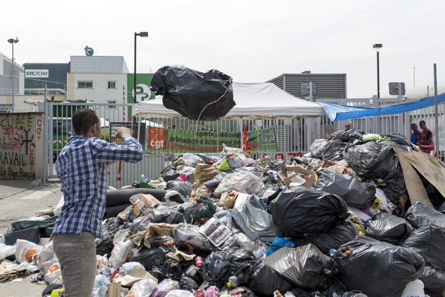 Garbage is piled up as striking garbage collectors block access to the Paris waste treatment center Friday in Ivry Sur Seine, near Paris.