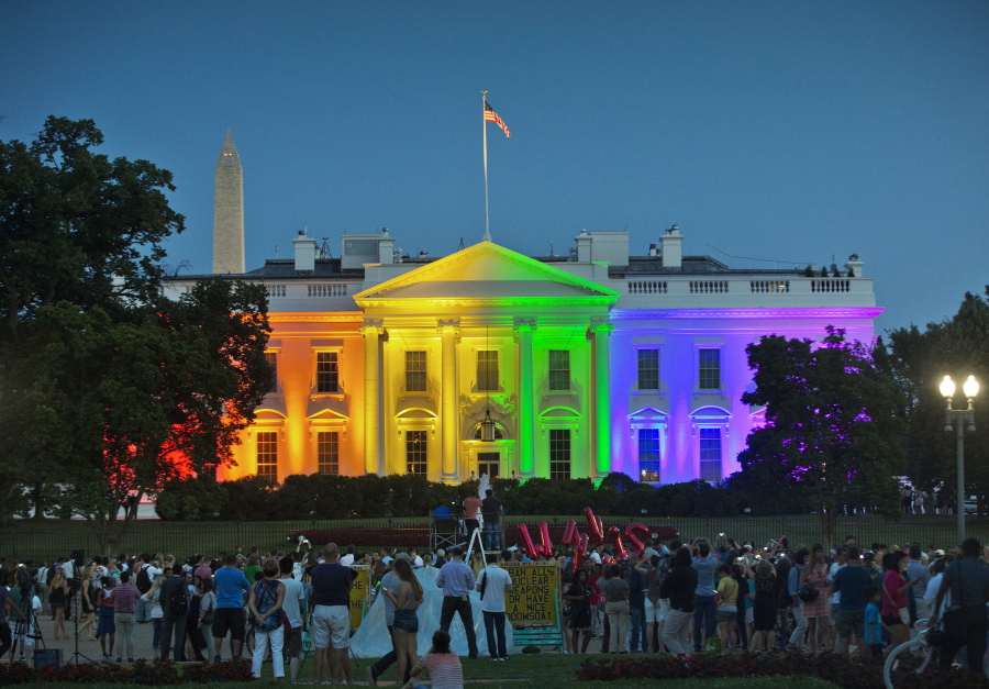 People gather in Washington&#039;s Lafayette Park on June 26, 2015, to see the White House illuminated with rainbow colors to mark the U.S. Supreme Court&#039;s ruling to legalize same-sex marriage.