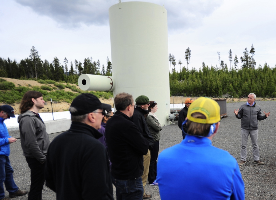 Alain Bonneville, right, a laboratory fellow with Pacific Northwest National Laboratory, talks about the process of making geothermal energy during a tour of the Newberry Geothermal Energy research facility at Newberry Crater near LaPine, Ore.