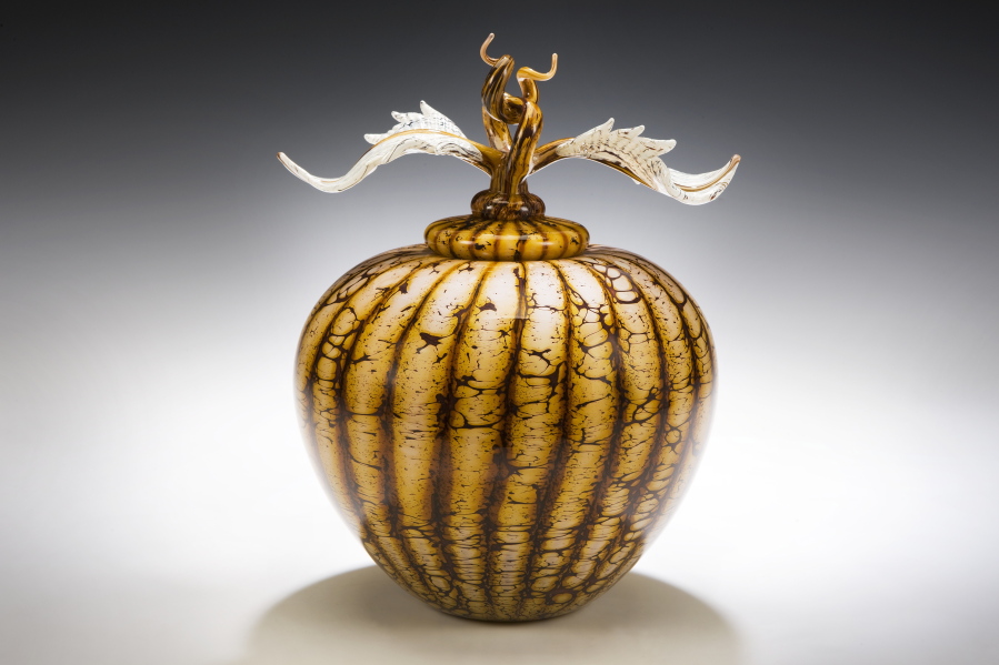 In this undated photo provided by Gartner/Blade, a Batik covered sphere with Avian finial from Danielle Blade and Stephen Gartner is shown. In their Strata collection of vases and vessels, tones of warm, earthy color are blown into layers that evoke geological terrain. Some of the design duo&#039;s objects come topped with surprising and exquisite touches, like a delicate snail&#039;s head; a sliver of animal bone or antler; or a curling leaf.